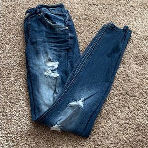 Distressed dark blue jeans